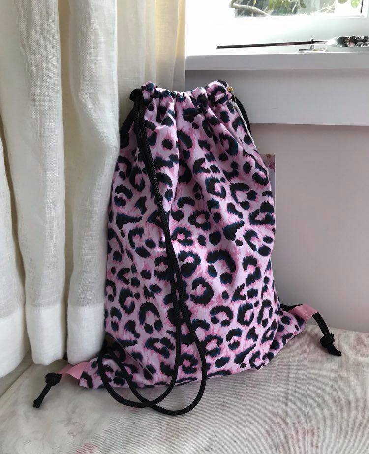 pink leopard with black straps and linen back $35